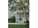 Charming two-story home featuring a blue front door, well-manicured landscaping, and a welcoming front porch at 338 Roberts Family Ln, Winter Springs, FL 32708