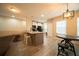 Well-lit kitchen island with seating, offering modern finishes and spaciousness at 338 Roberts Family Ln, Winter Springs, FL 32708