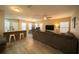 Open-concept living room with gray sofa, bar seating, and wood flooring at 338 Roberts Family Ln, Winter Springs, FL 32708