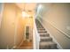 Carpeted staircase with white banister leading to the upper level, creating an elegant and functional transition at 338 Roberts Family Ln, Winter Springs, FL 32708