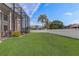 The landscaped backyard includes a lush lawn, an enclosed patio, and a white fence for enhanced privacy at 3656 Heirloom Rose Pl, Oviedo, FL 32766