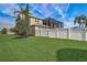 An enclosed patio and pristine white fence enhance the lush backyard of this beautiful home at 3656 Heirloom Rose Pl, Oviedo, FL 32766