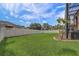 A well-maintained backyard features green lawn, bordered by a white fence and an enclosed patio with a hot tub at 3656 Heirloom Rose Pl, Oviedo, FL 32766
