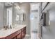 Bathroom features a dark wood vanity, a modern mirror, and a combined bathtub and shower at 3656 Heirloom Rose Pl, Oviedo, FL 32766