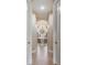 Hallway view into bathroom features tile flooring and mosaic tub with chandelier at 3656 Heirloom Rose Pl, Oviedo, FL 32766