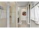 The bathroom features a tiled glass shower, a hanging towel rack, and an entryway to another room at 3656 Heirloom Rose Pl, Oviedo, FL 32766