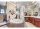 Bathroom featuring mosaic tiled tub, shower stall, chandelier, vanity and stool at 3656 Heirloom Rose Pl, Oviedo, FL 32766