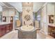 Bathroom featuring a tiled tub, dual shower stalls, chandelier, and vanity at 3656 Heirloom Rose Pl, Oviedo, FL 32766