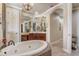 Open bathroom featuring mosaic tub, double vanity sinks, and hallway at 3656 Heirloom Rose Pl, Oviedo, FL 32766