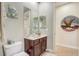 Cozy powder room features a single vanity with white sink and decorative elements at 3656 Heirloom Rose Pl, Oviedo, FL 32766