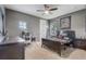 Cozy bedroom with neutral carpet, ceiling fan, and views of the backyard at 3656 Heirloom Rose Pl, Oviedo, FL 32766
