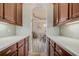 Hallway butler pantry with cabinets and countertops leading into the dining area at 3656 Heirloom Rose Pl, Oviedo, FL 32766