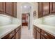 Hallway butler pantry with cabinets and countertops leading into the kitchen area at 3656 Heirloom Rose Pl, Oviedo, FL 32766
