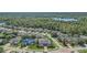 Aerial view showcasing a community surrounded by mature trees, waterways, and lush landscaping at 3656 Heirloom Rose Pl, Oviedo, FL 32766
