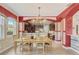 Open dining area with a chandelier, wood table and chairs connecting to an open kitchen space at 3656 Heirloom Rose Pl, Oviedo, FL 32766