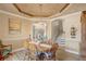 Beautiful dining area with chandelier lighting, neutral walls, and view of the stairway and arched entryway at 3656 Heirloom Rose Pl, Oviedo, FL 32766