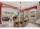 Open dining area connected to the living room features a chandelier and natural light from surrounding windows at 3656 Heirloom Rose Pl, Oviedo, FL 32766
