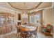Elegant dining area features custom ceiling, chandelier, and large window with curtains providing natural light at 3656 Heirloom Rose Pl, Oviedo, FL 32766
