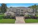 Elegant two-story home with stone accents, arched windows, and manicured landscaping at 3656 Heirloom Rose Pl, Oviedo, FL 32766