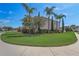 Landscaped front yard of a two-story house features healthy, green lawn and diverse trees and shrubs at 3656 Heirloom Rose Pl, Oviedo, FL 32766