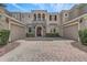 Stately home with stone detailing, multiple garages, and a brick-paved driveway at 3656 Heirloom Rose Pl, Oviedo, FL 32766
