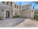 Elegant home featuring an attached garage, brick driveway, and stone accents at 3656 Heirloom Rose Pl, Oviedo, FL 32766