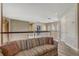 Hallway with wood-look floors, a comfortable sofa, and neutral decor creates a welcoming transition space at 3656 Heirloom Rose Pl, Oviedo, FL 32766