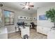 Home office with white desk, cabinets, light hardwood floors and a window with blinds at 3656 Heirloom Rose Pl, Oviedo, FL 32766