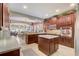 Bright kitchen with wood cabinets, stainless appliances, an island and white countertops at 3656 Heirloom Rose Pl, Oviedo, FL 32766