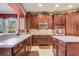 Bright kitchen with wood cabinets, stainless appliances, an island and white countertops at 3656 Heirloom Rose Pl, Oviedo, FL 32766