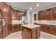 Bright kitchen with wood cabinets, stainless appliances, an island and white countertops at 3656 Heirloom Rose Pl, Oviedo, FL 32766