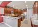 Bright kitchen with wood cabinets, stainless appliances, an island and white countertops at 3656 Heirloom Rose Pl, Oviedo, FL 32766