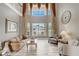 Bright living room with soaring ceilings, large windows, and stylish furnishings at 3656 Heirloom Rose Pl, Oviedo, FL 32766