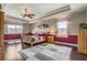 Spacious primary bedroom with tray ceilings, decorative windows, and wood flooring at 3656 Heirloom Rose Pl, Oviedo, FL 32766