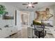 Bright office featuring hardwood floors, a ceiling fan, dual monitors, and views into the living area at 3656 Heirloom Rose Pl, Oviedo, FL 32766
