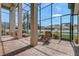 Enclosed outdoor patio with brick floors and multiple seating areas at 3656 Heirloom Rose Pl, Oviedo, FL 32766