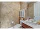 Powder room with toilet, sink, decorative mirror and textured wall finish at 3656 Heirloom Rose Pl, Oviedo, FL 32766