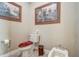 Toilet featuring a bidet, roll of paper and wall decorations at 3656 Heirloom Rose Pl, Oviedo, FL 32766