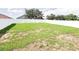 Large, grassy backyard enclosed by a white fence at 398 Citrus Isle Loop, Davenport, FL 33837