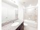 Bright bathroom featuring a granite countertop vanity, tiled shower, and bathtub at 398 Citrus Isle Loop, Davenport, FL 33837