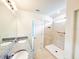 Bathroom featuring granite countertops, dual sinks and a tiled shower at 398 Citrus Isle Loop, Davenport, FL 33837