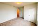 Neutral bedroom with carpet, closet, and entry door showing view to hallway at 398 Citrus Isle Loop, Davenport, FL 33837