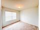 Empty bedroom with a window and neutral carpet at 398 Citrus Isle Loop, Davenport, FL 33837