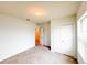 Bedroom featuring carpet flooring, closet space, and a window providing natural light at 398 Citrus Isle Loop, Davenport, FL 33837
