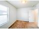 Bedroom featuring a window, carpet flooring, and a door leading to other areas of the home at 398 Citrus Isle Loop, Davenport, FL 33837