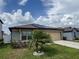 Charming home featuring solar panels, well-manicured lawn, and a two-car garage at 398 Citrus Isle Loop, Davenport, FL 33837