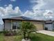 Charming home featuring solar panels, well-manicured lawn, and a two-car garage at 398 Citrus Isle Loop, Davenport, FL 33837