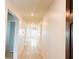 Hallway with tiled flooring leads to the living area, offering a bright and open feel at 398 Citrus Isle Loop, Davenport, FL 33837