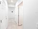 Well-lit hallway with tile flooring and multiple doors at 398 Citrus Isle Loop, Davenport, FL 33837