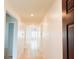 Hallway featuring neutral paint, ceramic tile flooring, and access to bedrooms, bathrooms, and living areas at 398 Citrus Isle Loop, Davenport, FL 33837
